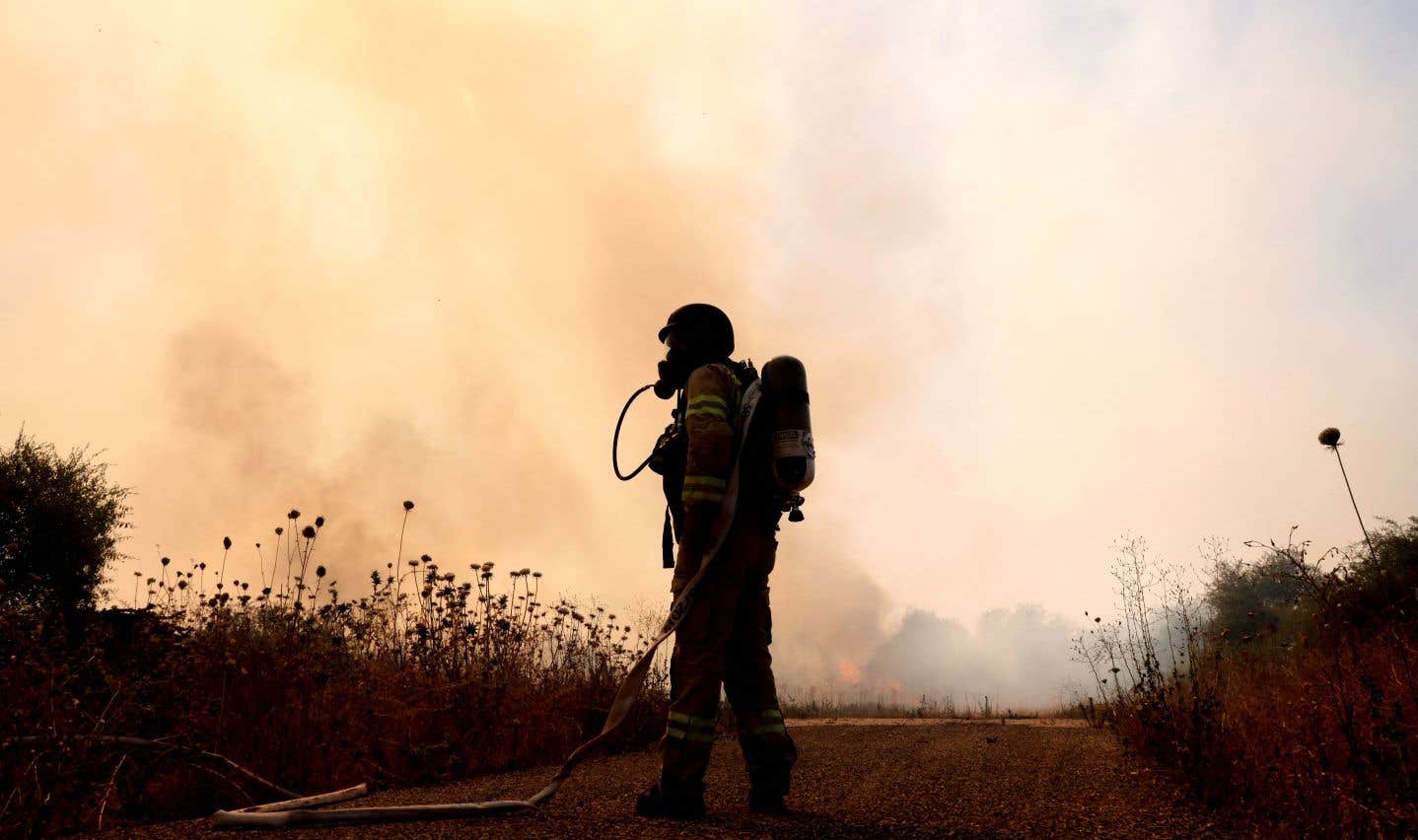 Un pompier déployé dans le nord d’Israël, le 25 juin 2024, pour éteindre un incendie causé par un tir de drone depuis le sud du Liban, au milieu d’affrontements transfrontaliers entre les troupes israéliennes et les combattants du Hezbollah